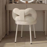 Boucle vanity stool with butterfly-shaped backrest in pink, green, and white colors